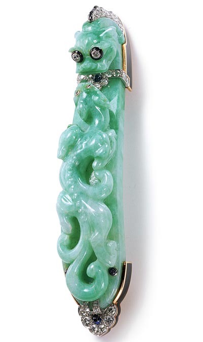 - <b>Broche Dragons</b> - Cartier Paris, commande de 1924 - Or, platine, diamants, saphirs, jade, émail. Cette broche fut exécutée à partir d’une agrafe de ceinture en jade gravé du XVIII<sup>e</sup> ou du XIX<sup>e</sup> siècle, remise par le client. Collection Cartier - Nick Welsh, Collection Cartier © Cartier